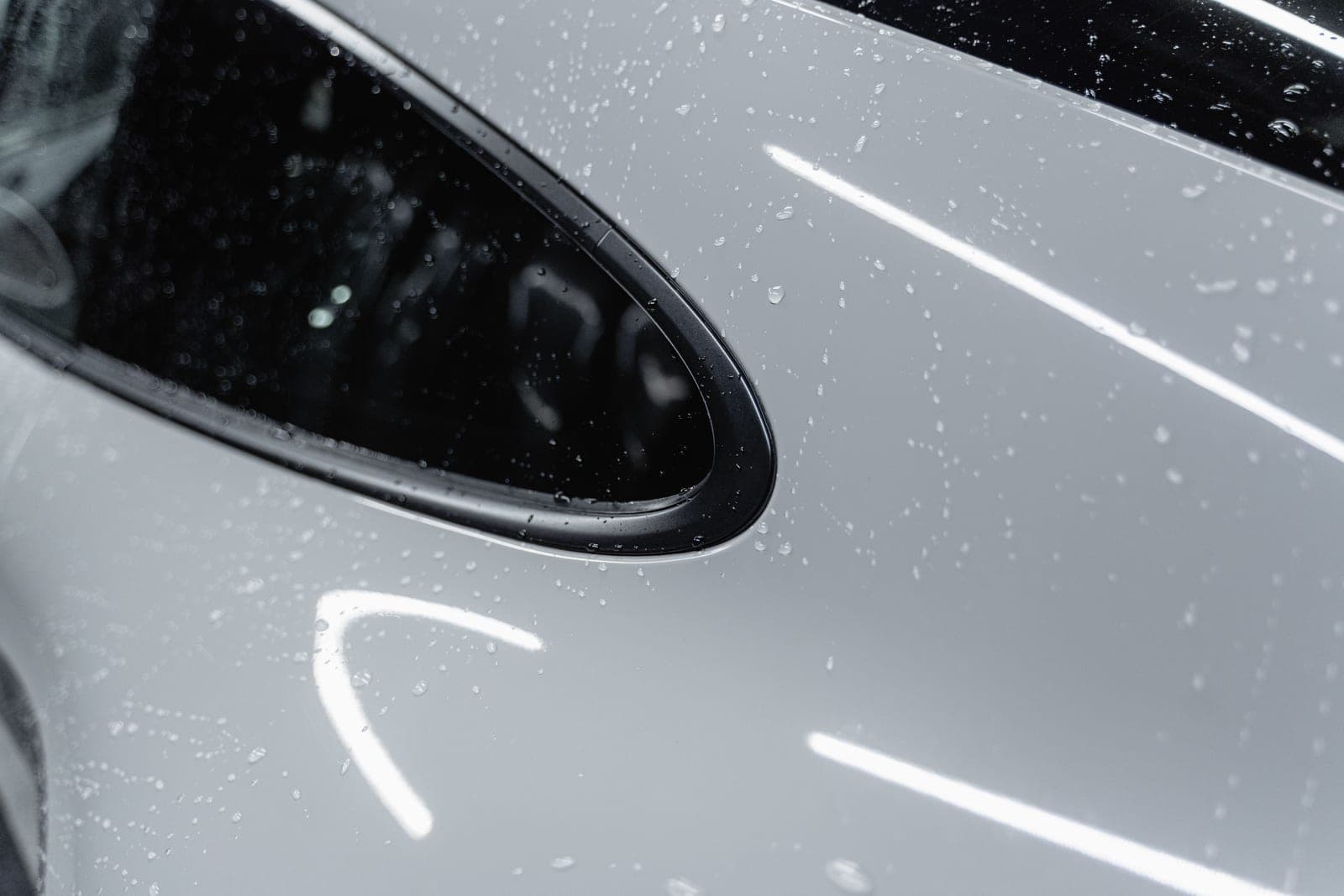 Water beading on a freshly ceramic-coated, mirror-gloss car panel